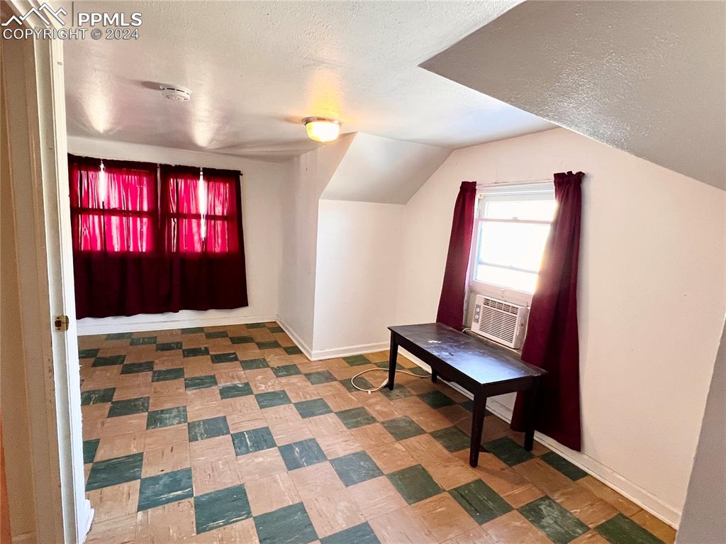 408 9th Street Fowler, CO 81039 - Photo 10 of 13 a view of a hallway with wooden floor and a chair