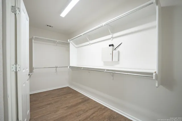 a view of a room with wooden floor and white doors