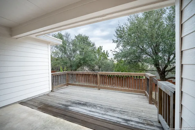 a view of deck with two chairs and wooden fence