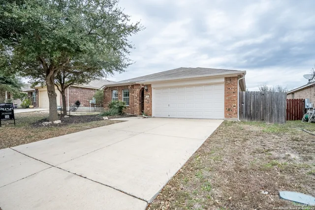 a view of a house with a yard and garage
