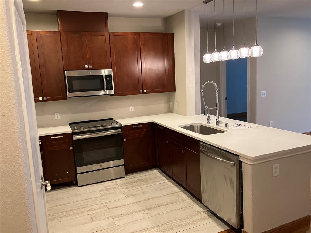 1220 West Trinity Mills Road, Unit 5009 Carrollton, TX 75006 - Photo 4 of 25 a kitchen with a sink appliances and cabinets