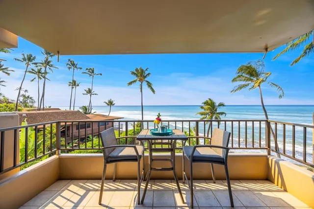 a view of a chairs and table in the balcony