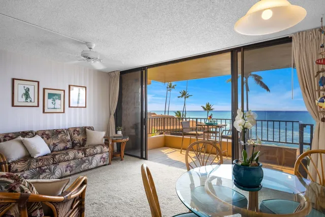 a living room with couches a coffee table and next to a window