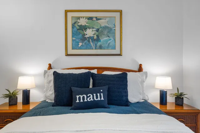 a bedroom with a bed and a lamp on table