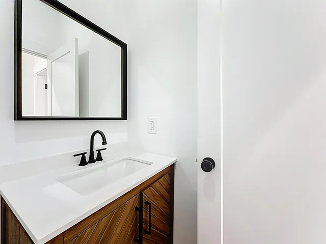 a bathroom with a sink a mirror and shower
