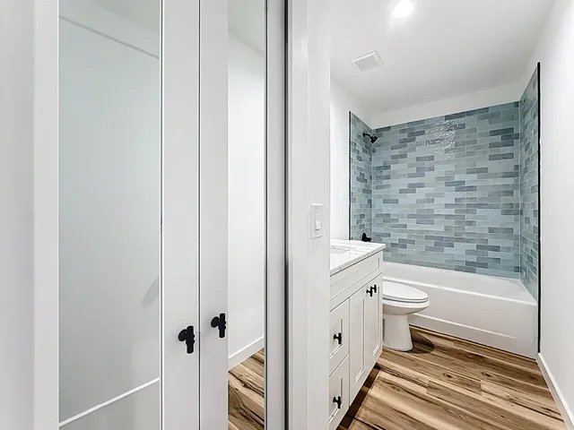 a bathroom with a toilet a sink and bathtub