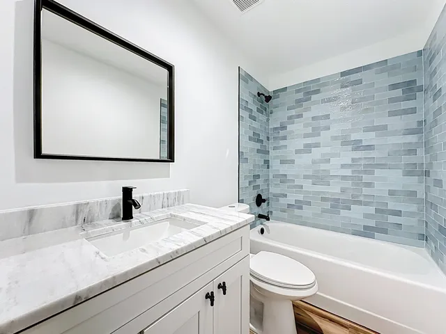 a bathroom with a sink a toilet and a bathtub