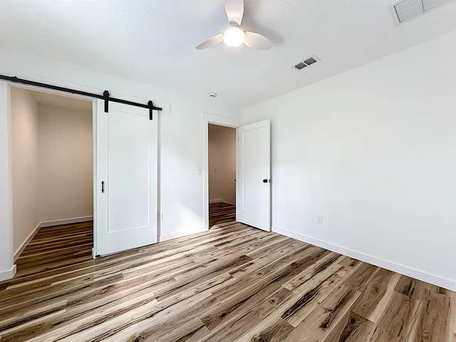 a view of a room with wooden floor