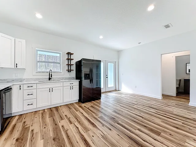 a kitchen with stainless steel appliances a refrigerator sink and cabinets