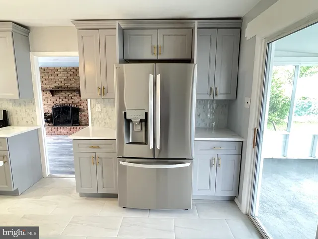 a kitchen with a refrigerator and a sink