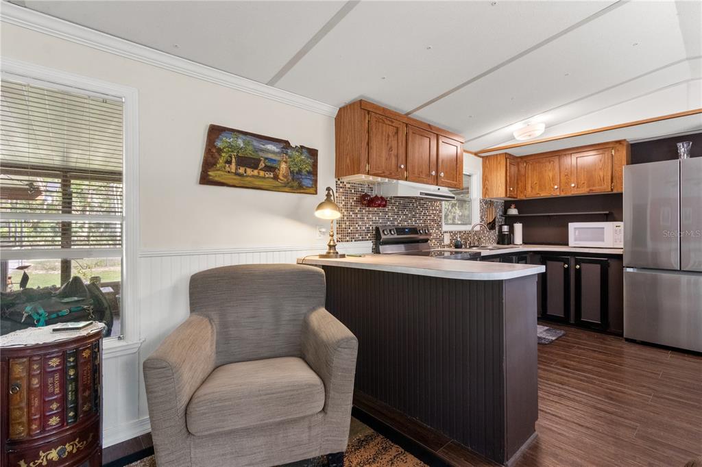 3650 176 Place Inglis, FL 34449 - Photo 18 of 52 a kitchen with kitchen island granite countertop a sink cabinets and wooden floor