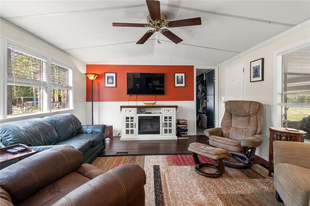 3650 176 Place Inglis, FL 34449 - Photo 27 of 52 a living room with furniture and a fireplace