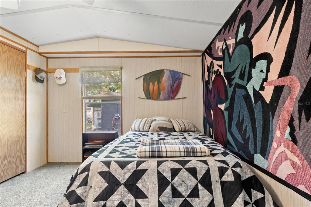 3650 176 Place Inglis, FL 34449 - Photo 29 of 52 a bedroom with a bed and a painting on the wall