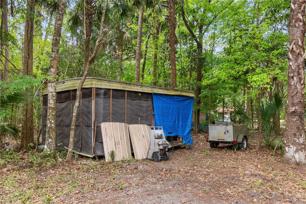 3650 176 Place Inglis, FL 34449 - Photo 44 of 52 a backyard of a house with a large tree and wooden fence