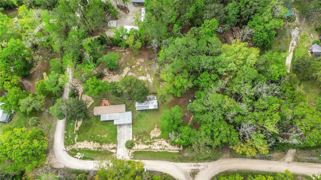 3650 176 Place Inglis, FL 34449 - Photo 46 of 52 an aerial view of a house with a yard and large trees