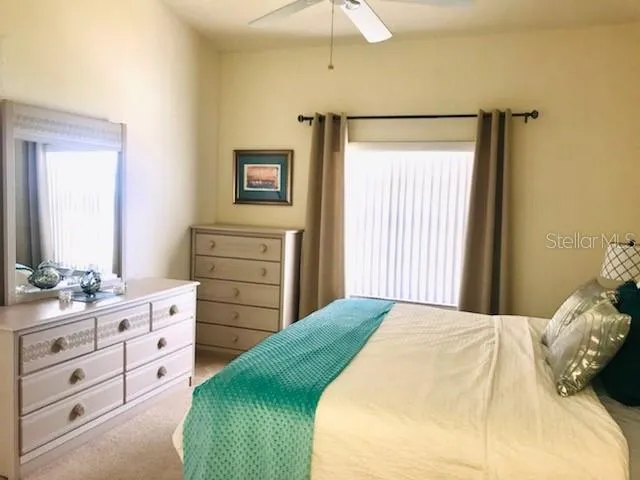 a bedroom with a bed and a dresser