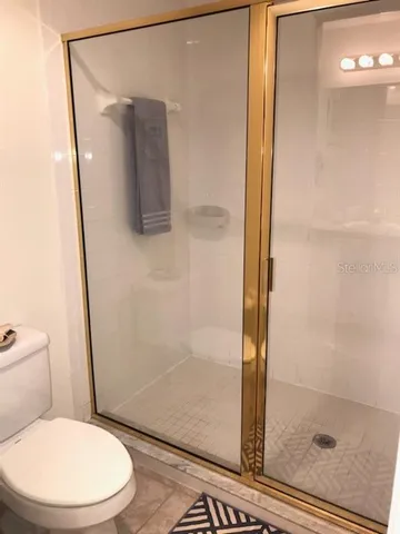 a white toilet sitting next to a bathroom sink