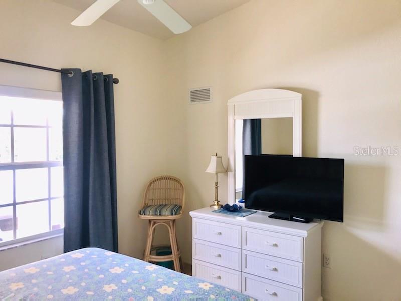 26397 Nadir Road, Unit 204 Punta Gorda, FL 33983 - Photo 15 of 26 a bedroom with a bed and a flat screen tv