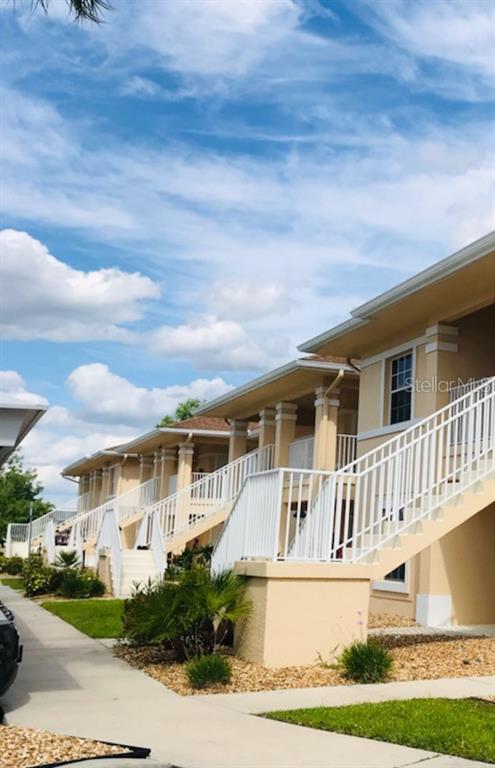 26397 Nadir Road, Unit 204 Punta Gorda, FL 33983 - Photo 2 of 26 a front view of a house with a yard
