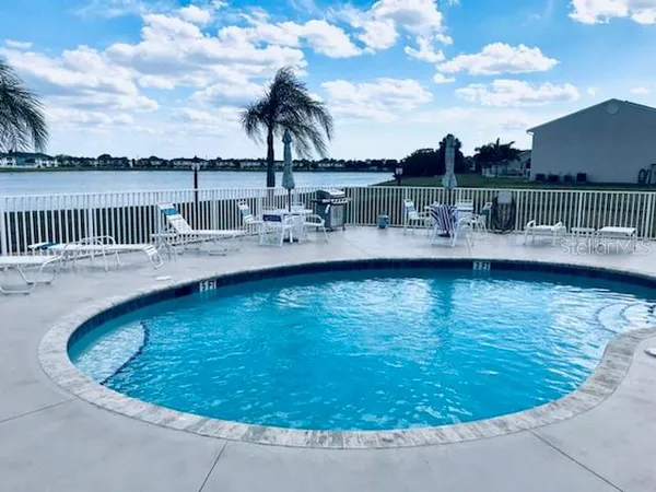 a view of a swimming pool with a lake view