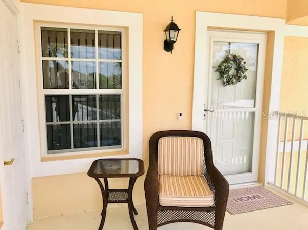 a view of a balcony with chair and front door