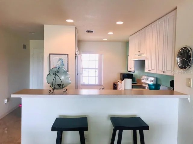 a kitchen with table chair and window