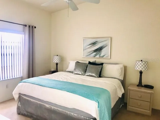 a bedroom with a bed and a painting