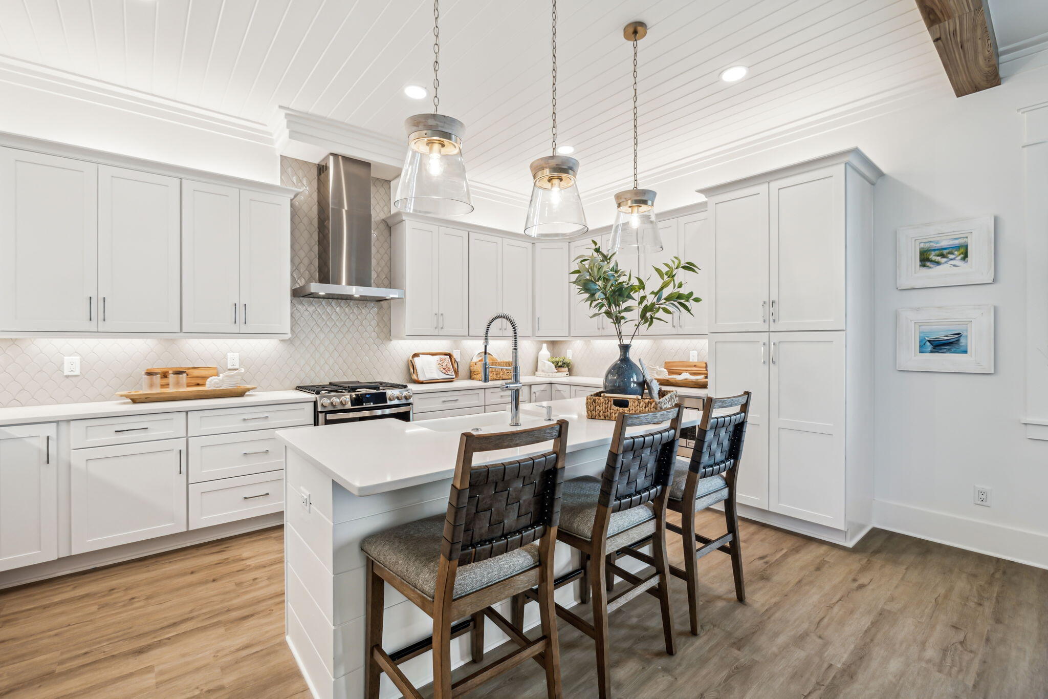 33 Grayton Boulevard Santa Rosa Beach, FL 32459 - Photo 9 of 48 a kitchen with stainless steel appliances granite countertop white cabinets a refrigerator a sink a stove a dining table and chairs