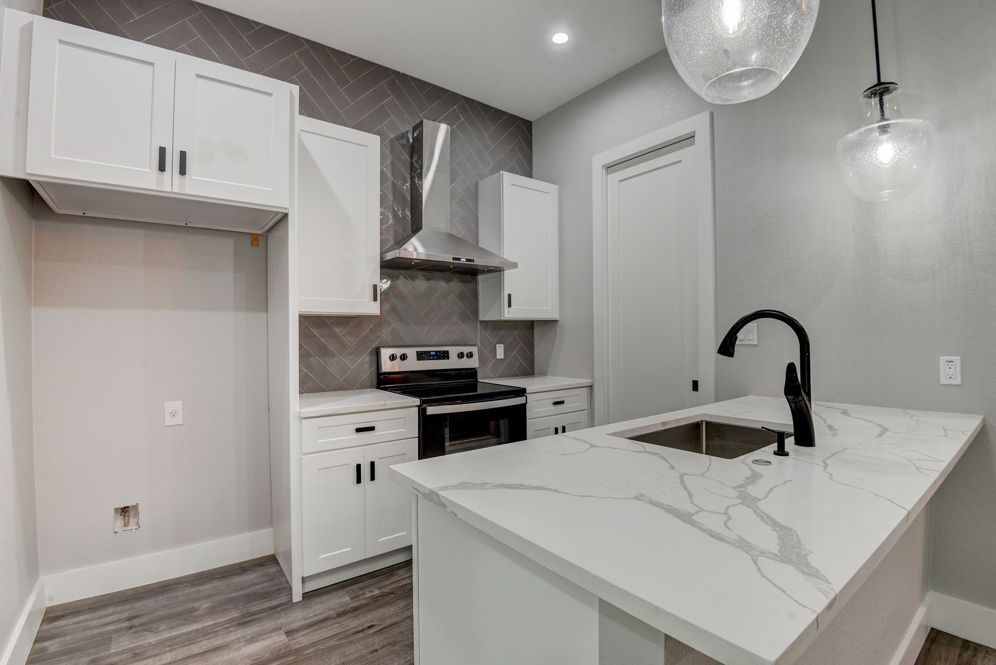 2507 Rogge Lane, Unit 2 Austin, TX 78723 - Photo 12 of 30 a kitchen with stainless steel appliances a stove refrigerator sink and cabinets