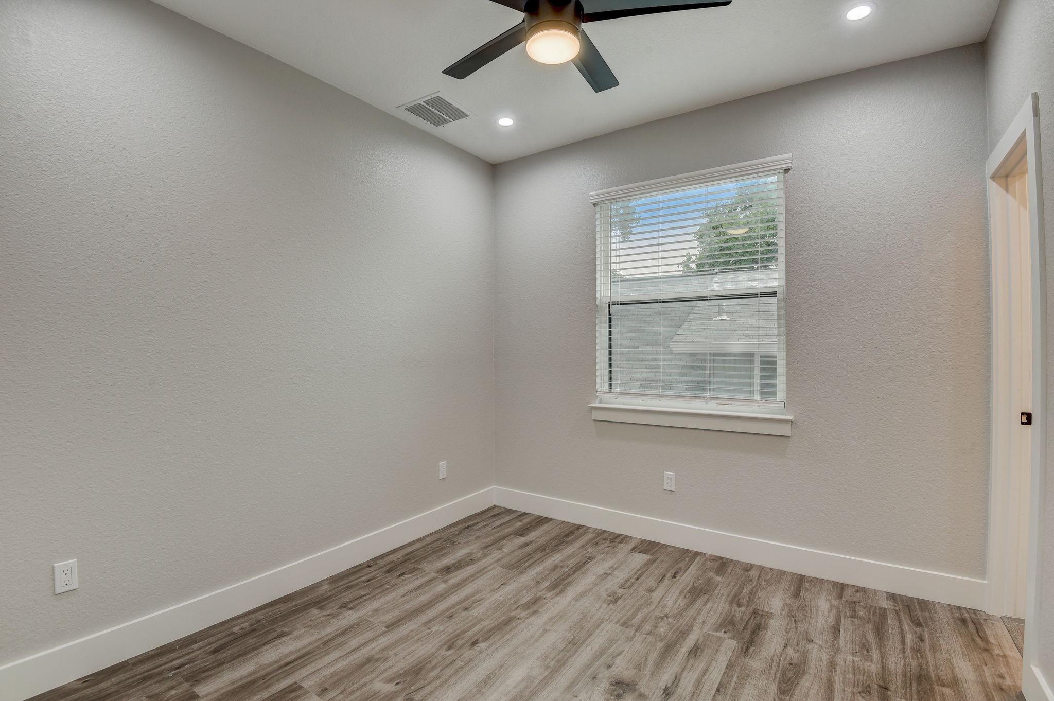 2507 Rogge Lane, Unit 2 Austin, TX 78723 - Photo 18 of 30 an empty room with a window and a ceiling fan
