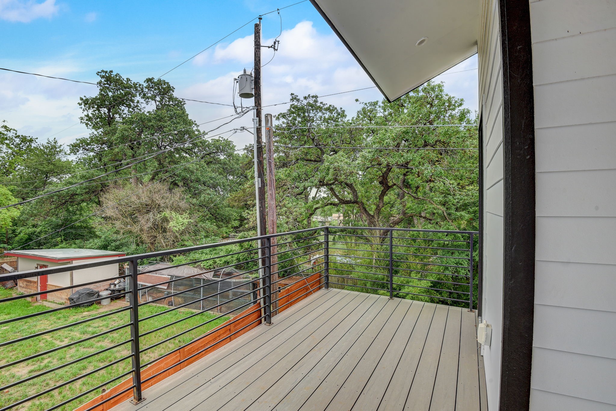2507 Rogge Lane, Unit 2 Austin, TX 78723 - Photo 25 of 30 a view of a balcony with floor to ceiling windows with wooden floor