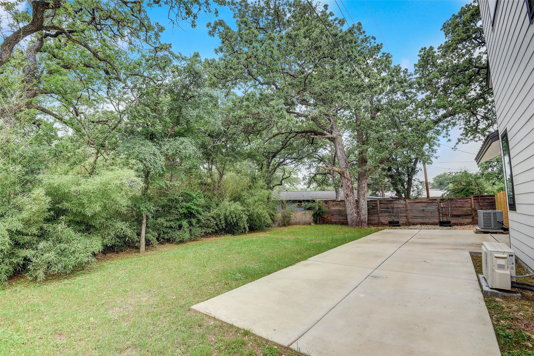 2507 Rogge Lane, Unit 2 Austin, TX 78723 - Photo 28 of 30 a view of a backyard with a garden and trees