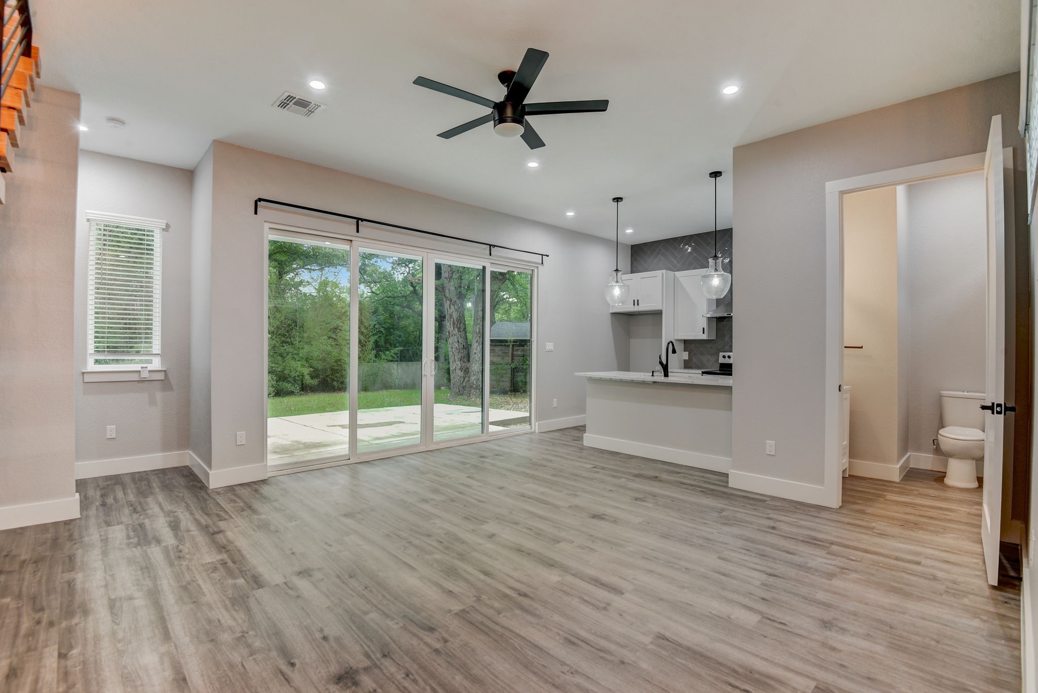 2507 Rogge Lane, Unit 2 Austin, TX 78723 - Photo 9 of 30 a view of an empty room with a window and wooden floor