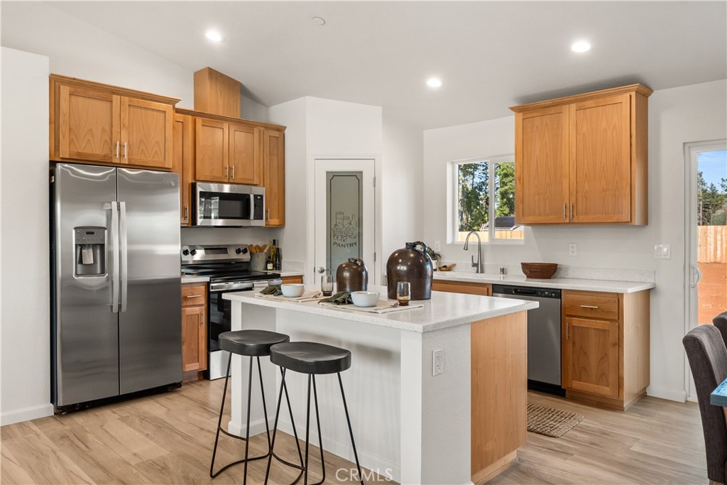 5956 Kibler Road Paradise, CA 95969 - Photo 11 of 36 a kitchen with stainless steel appliances a sink cabinets and wooden floor