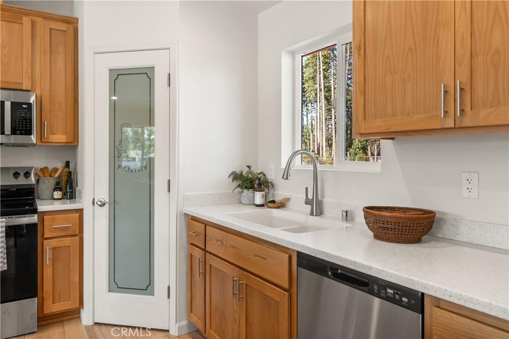 5956 Kibler Road Paradise, CA 95969 - Photo 13 of 36 a kitchen with stainless steel appliances granite countertop white cabinets and a potted plant
