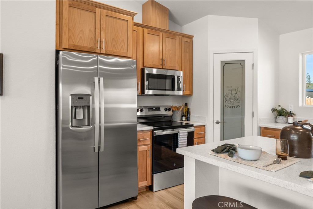 5956 Kibler Road Paradise, CA 95969 - Photo 16 of 36 a kitchen with stainless steel appliances granite countertop a refrigerator a stove and a sink