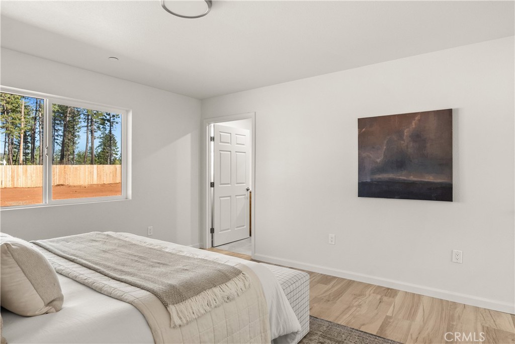 5956 Kibler Road Paradise, CA 95969 - Photo 18 of 36 a bedroom with a bed and wooden floor
