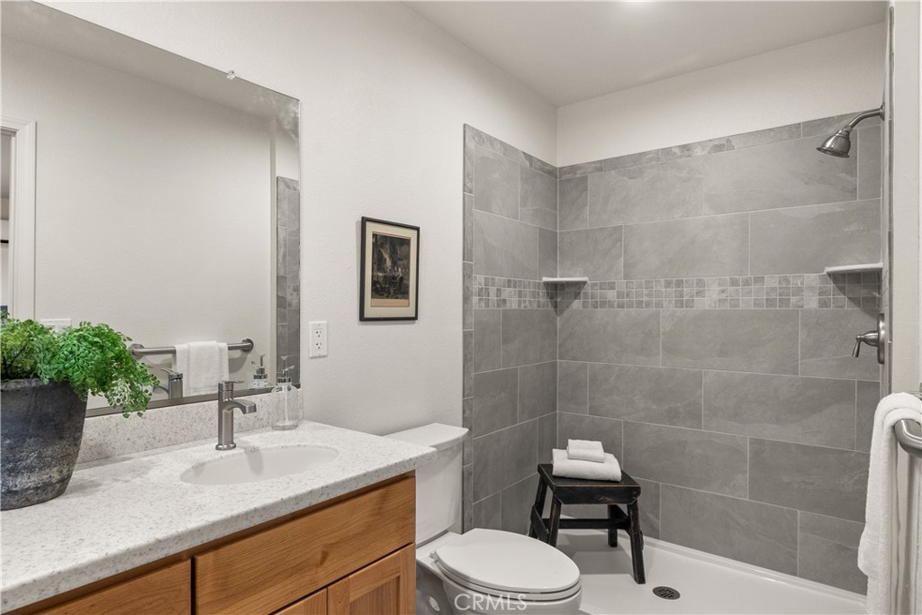 5956 Kibler Road Paradise, CA 95969 - Photo 19 of 36 a bathroom with a sink a toilet a mirror and shower