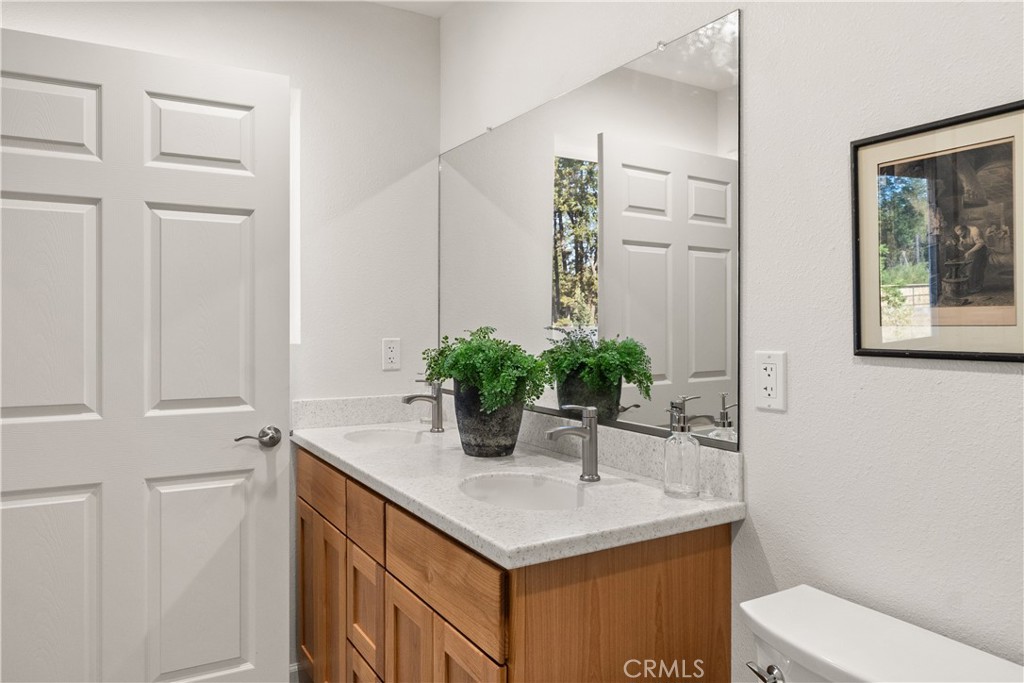 5956 Kibler Road Paradise, CA 95969 - Photo 20 of 36 a bathroom with a sink a toilet and mirror