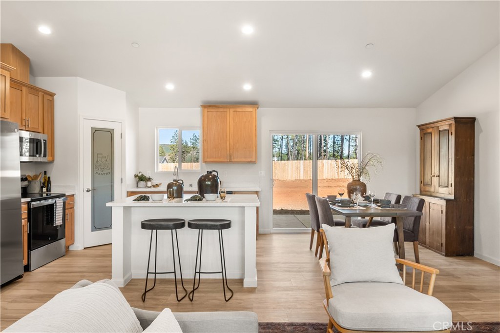 5956 Kibler Road Paradise, CA 95969 - Photo 10 of 36 a kitchen with a table chairs stove and refrigerator