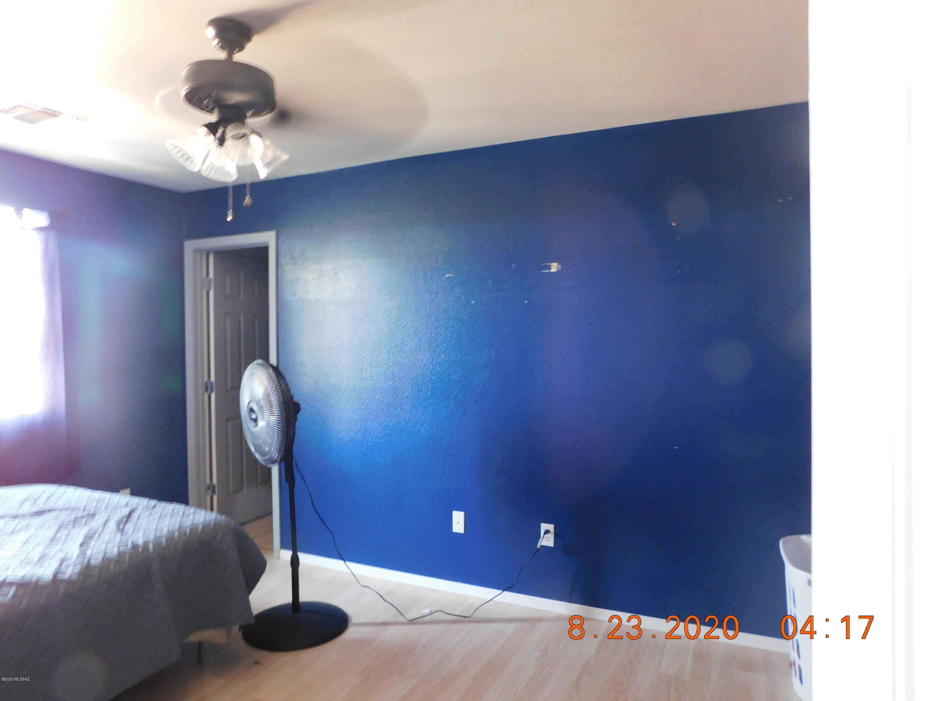20827 East Reunion Road Red Rock, AZ 85145 - Photo 14 of 19 a bedroom with a bed and a chandelier