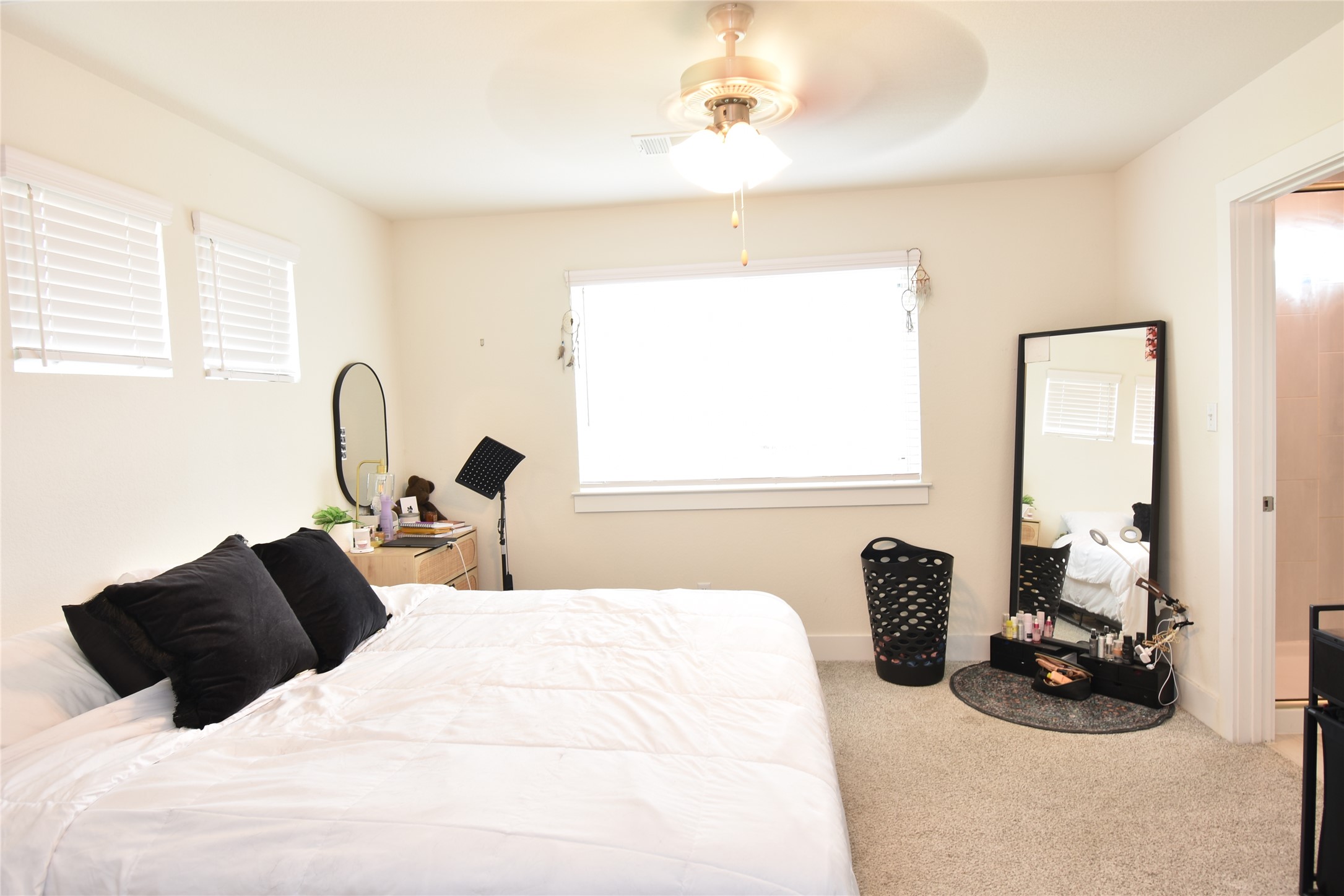 331 Alamar Knot Way, Unit 208 Georgetown, TX 78626 - Photo 3 of 17 A well-lit bedroom offering soft carpet flooring and a refreshing ceiling fan for comfort.