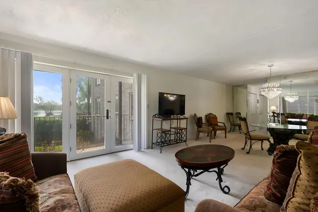 a living room with furniture a rug and a large window
