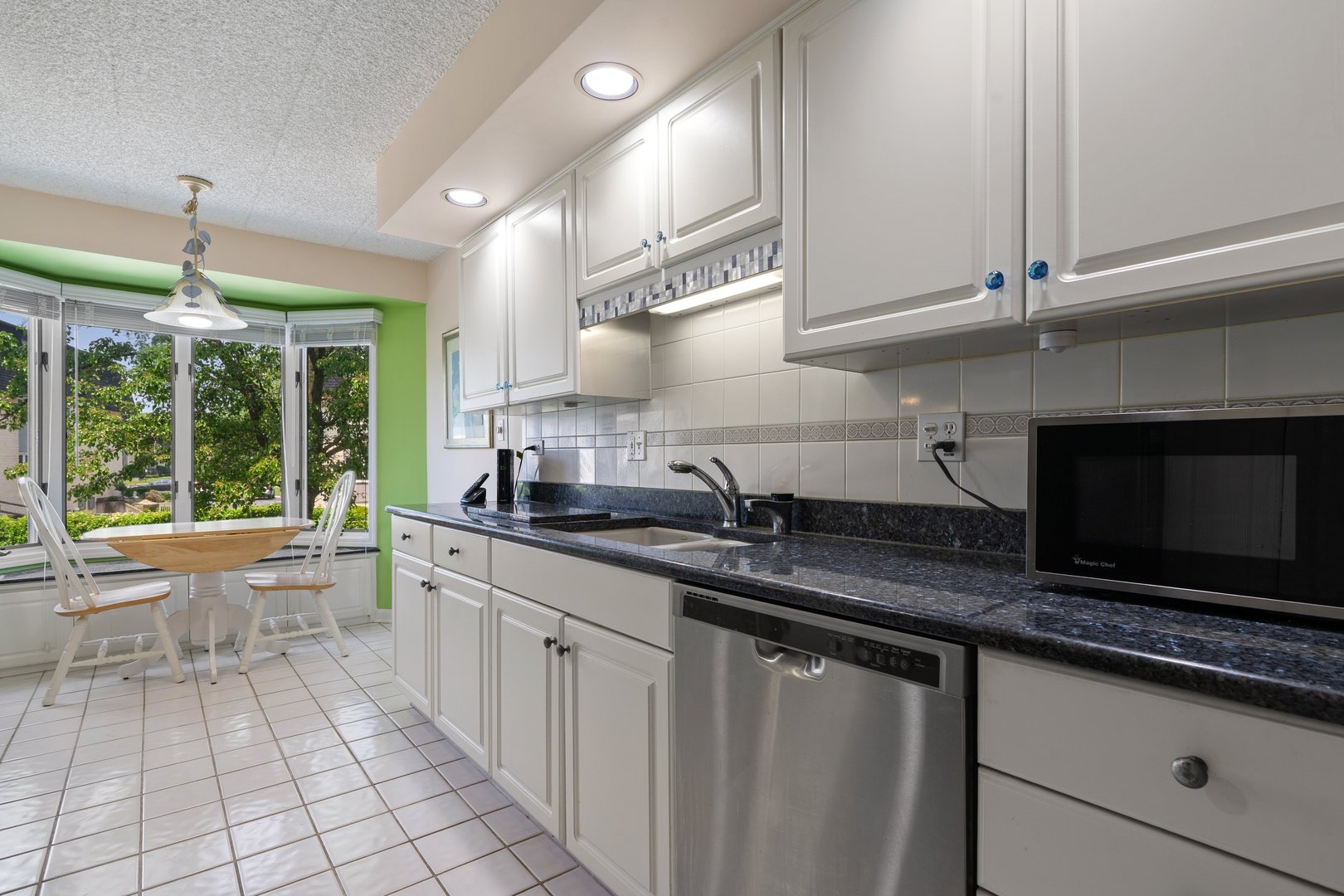 3640 186th Street, Unit 101 Lansing, IL 60438 - Photo 7 of 17 a kitchen with granite countertop a sink and a stove