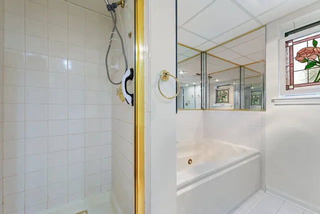 a bathroom with a tub shower vanity and a sink
