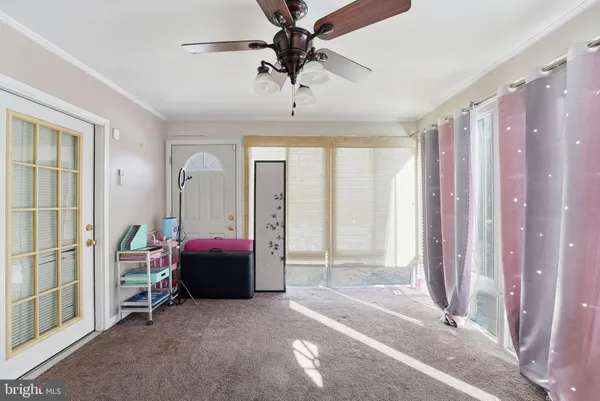 a living room with a large bed and a chandelier
