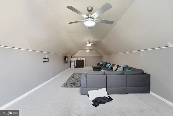a living room with couch and ceiling fan