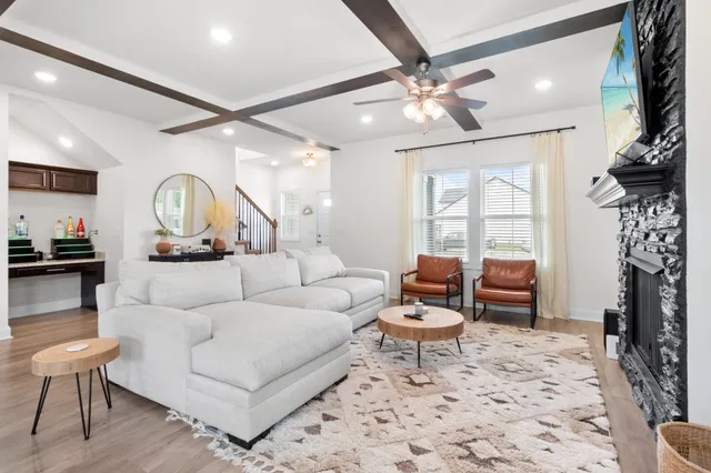 a living room with furniture a table and decor