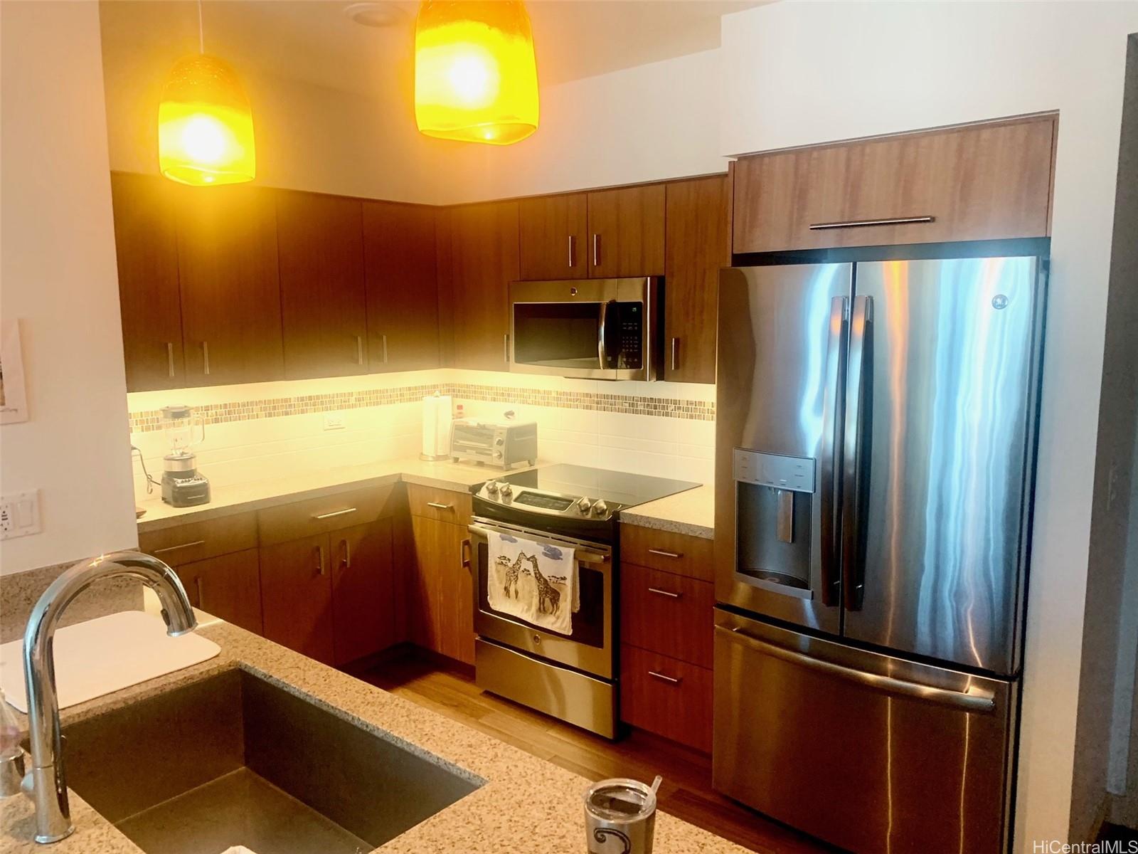 a kitchen with stainless steel appliances granite countertop a refrigerator and a sink