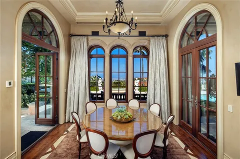 a kitchen that has a lot of cabinets and wooden floor